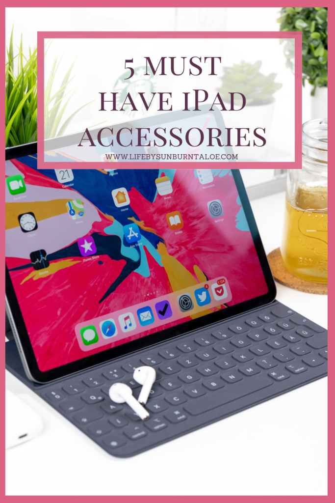 iPad sitting on a desk with a keyboard and AirPods .